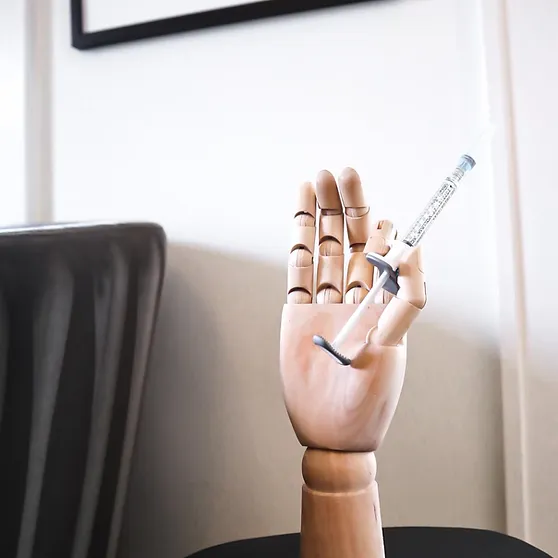 hand holding a syringe at monroe medspa